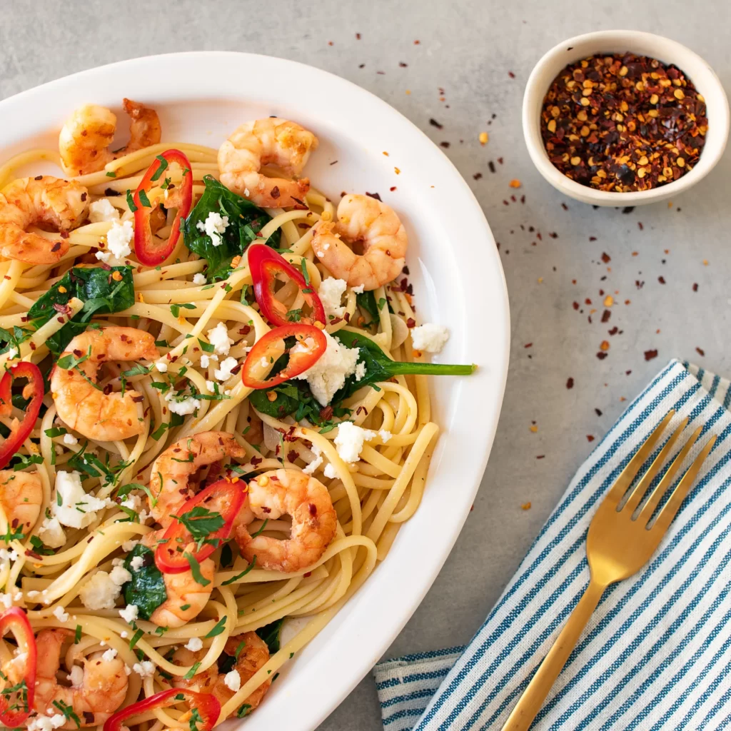 Spice Up Your Dinner with Seared Prawn Pasta featuring Chilli, Feta, and Spinach